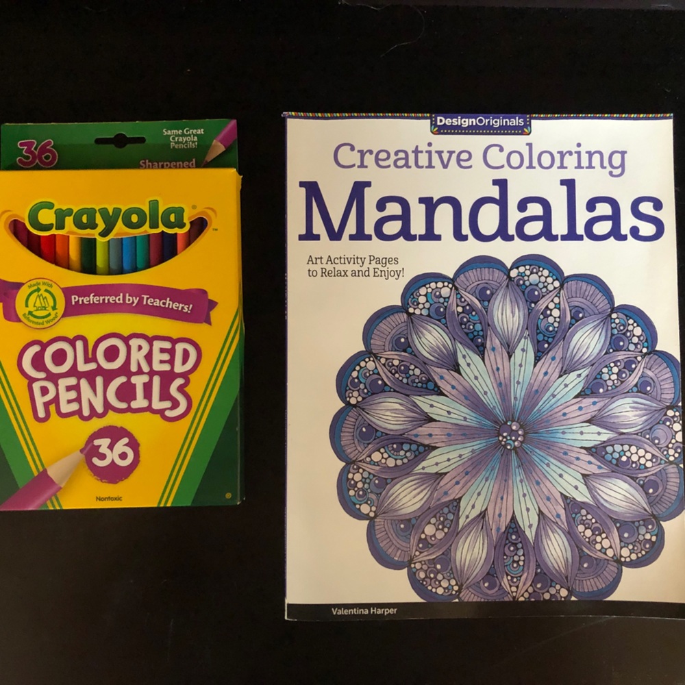 Mandalas coloring book with never opened pencils